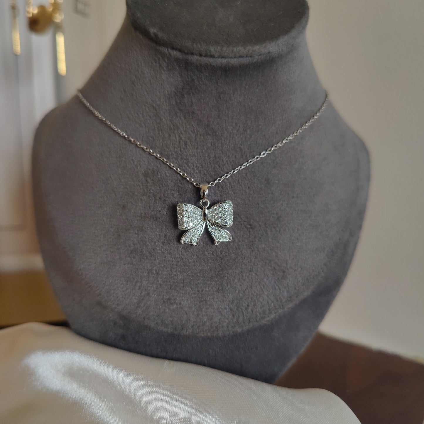 Silver bow neckpiece