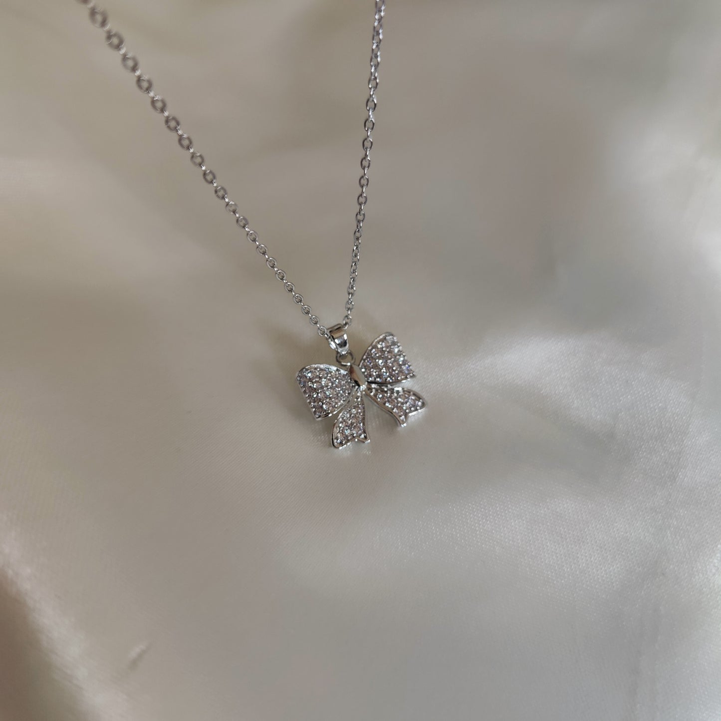 Silver bow neckpiece